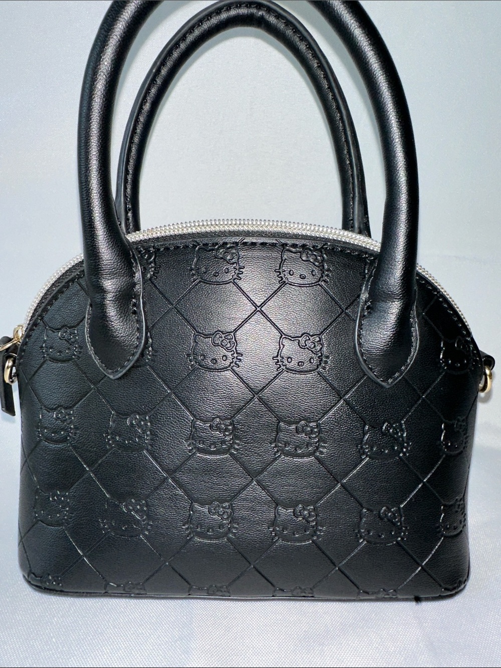Black Hello Kitty embossed mini dome bag